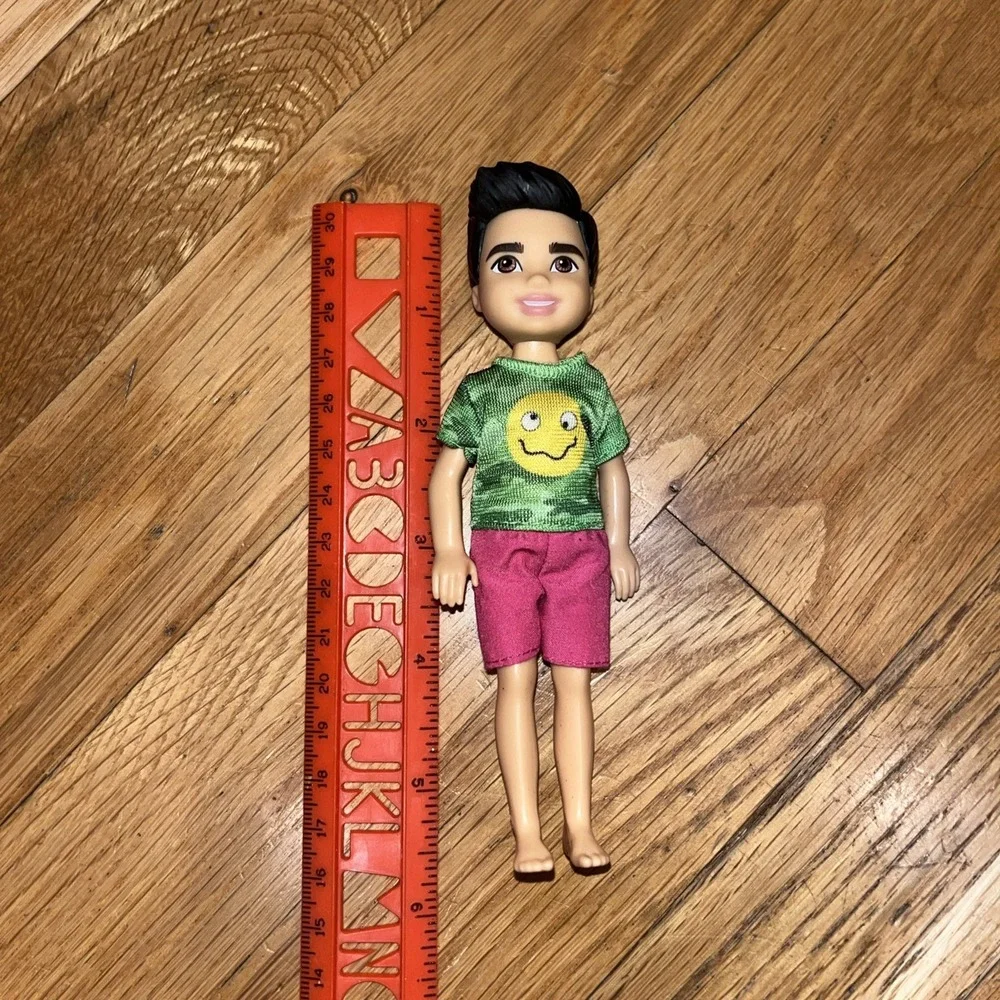 BARBIE CHELSEA DOLL- Brunette BOY Green Camo Shirt Smiley Emoji- Mattel